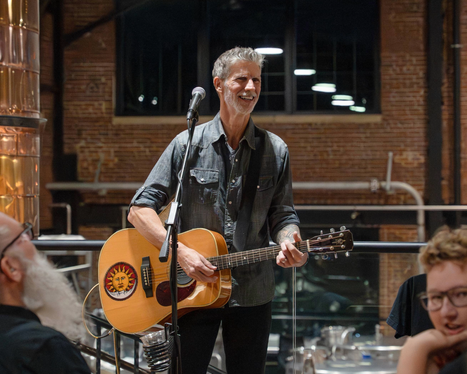Scott Blasey with a guitar in front of a microphone